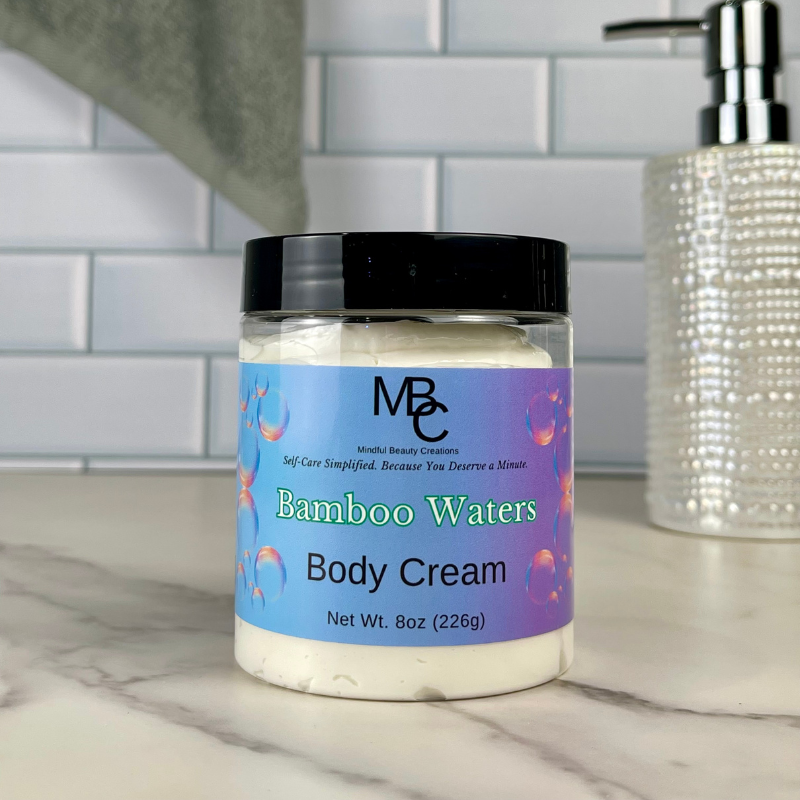 Jar of Bamboo Waters Body Cream on a bathroom counter with a tiled wall background