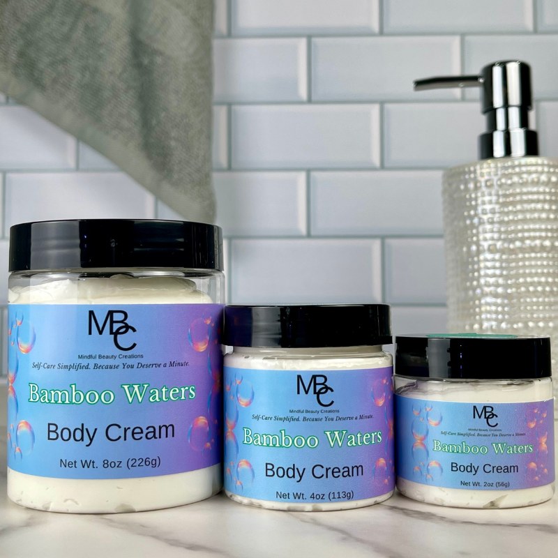 Three jars of Bamboo Waters Body Cream on a marble surface with a tiled wall background.