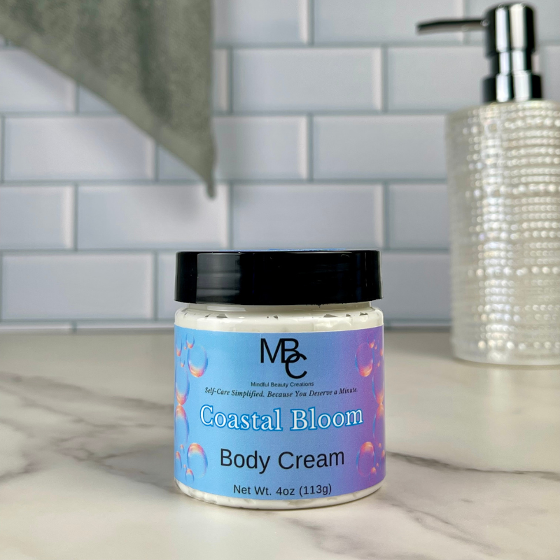 Coastal Bloom Body Cream jar on a marble countertop with a tiled wall background