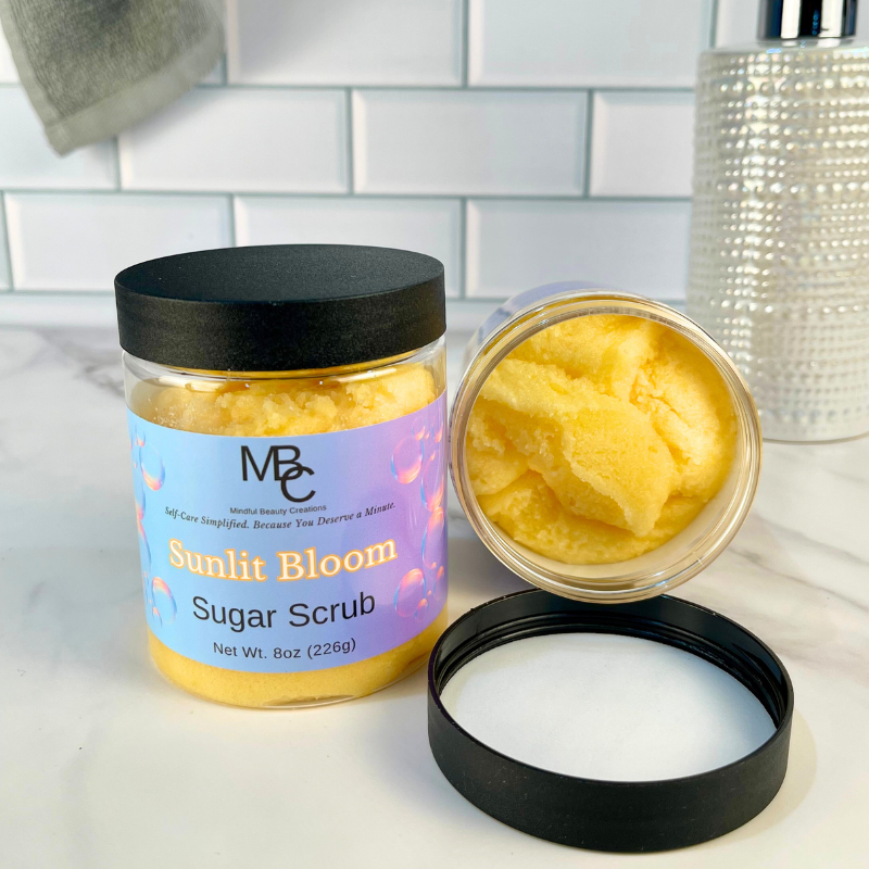 Sunlit Bloom Sugar Scrub jar with open lid on a white surface