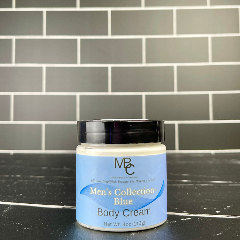 Jar of Men's Collection Blue Body Cream on a black surface with a tiled wall background