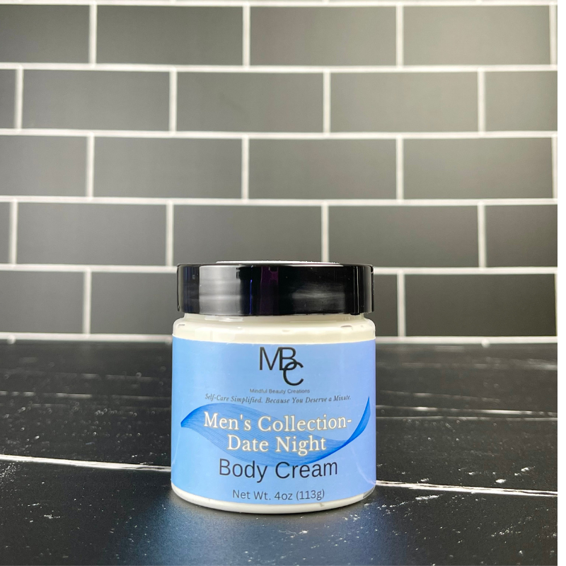 Jar of Men's Collection Date Night Body Cream on a black surface with a tiled wall background
