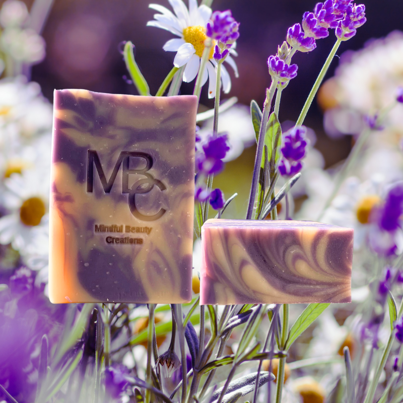 Close up of the front and top of a purple and tan swirl pattern handmade bar soap. Lavender and Chamomile scent